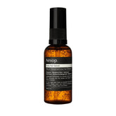 Sérum Tame d'Aesop, bouteille élégante, dompte les frisottis sans alourdir
