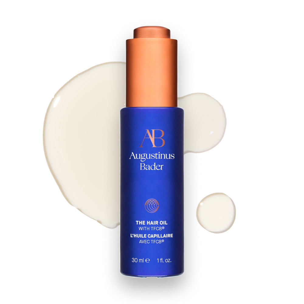 Huile capillaire Augustinus Bader dans sa bouteille, hydratation efficace pour les longueurs.