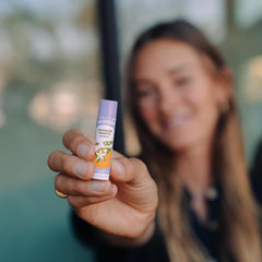 Badger Lavender Orange lip balm on lips with subtle shine.