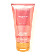 Bath & Body Works Champagne Toast, bouteille de crème hydratante et parfum festif.
