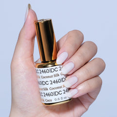 DAISY DND Coconut Silk lacquer bottle paired with gel polish for a coordinated mani.