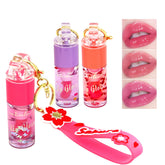 DENESTUP gloss rose avec pendentif sakura, éclat lumineux et hydratation légère.