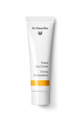 Dr. Hauschka Crème teintée jour — visage et flacon, hydratation légère pour un éclat naturel.
