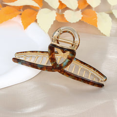 Barrettes FAELBATY papillon acétate brun-vert pour un look élégant.