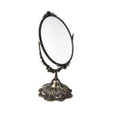 Miroir Feyarl vintage oval sur table avec cadre floral, élégant et durable.