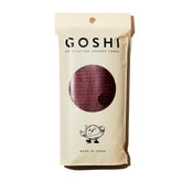 GOSHI serviette exfoliante rouge brique; texture résistante pour un gommage en profondeur.