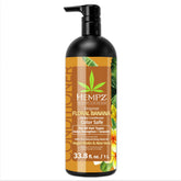 Hempz après-shampooing biotine : bouteille florale et banane pour nourrir les cheveux.