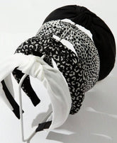 Bandeau Huachi avec nœud noir, maintien fiable et style élégant.
