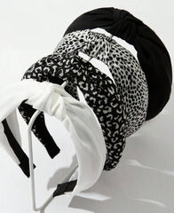 Bandeau Huachi avec nœud noir, maintien fiable et style élégant.