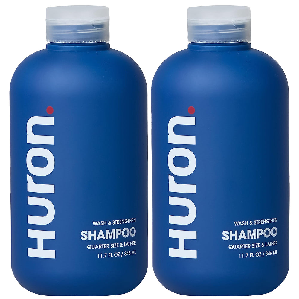 Shampoing Huron Citrus Bois pour homme, bouteille et étiquette visibles, hydratation potentielle.