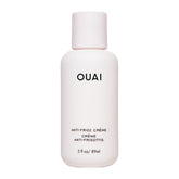 OUAI Crème Anti-Frizz Voyage: bouteille compacte pour cheveux lisses et sans frisottis.