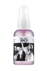 R+Co huile lissage miroir deux voies sur bouteille, offre brillance sans alourdir les cheveux.