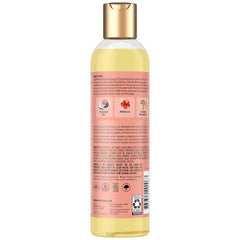 SheaMoisture huile massage illuminante, bouteille élégante, texture riche et soin nourrissant.