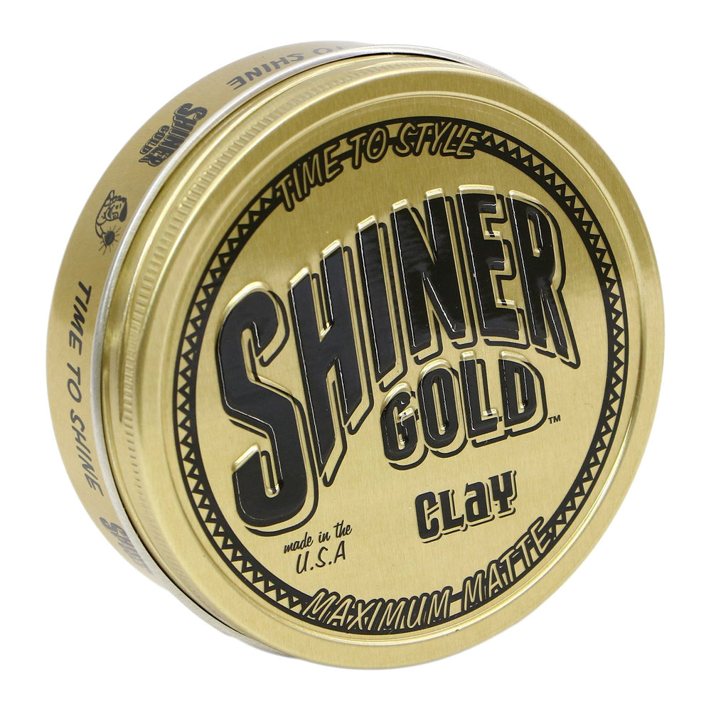 Shiner Gold Pommade Argile, bouteille visible montrant le maintien fort.