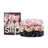 SLIP scrunchie large en soie rose, texture satinée qui glisse sans accrocher.