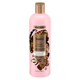Bouteille Suave Professionnels montrant beurre de karité et huile de coco pour boucles hydratées.