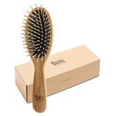 Brosse TEK oval en frêne naturel avec dents courtes pour démêler en douceur.