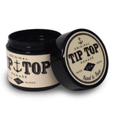Pommade TIP TOP Originale dans sa bouteille, offre une tenue généreuse et une brillance naturelle.
