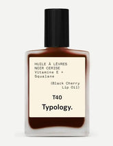 Typology huile teintante lèvres cerise noire sur flacon, gloss nourrissant et couleur subtile.