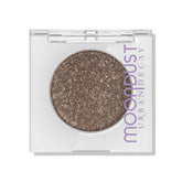Urban Decay Moondust Diamond Dog, poudre brun avec micro-perles dorées et argentées pour un éclat durable.
