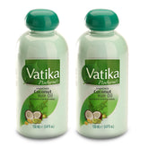 Vatika Dabur coconut oil bottle pour for easy application and nourishment.