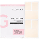 ZitSticka Goo Getter patch sur le corps couvrant un bouton et protégeant la zone.