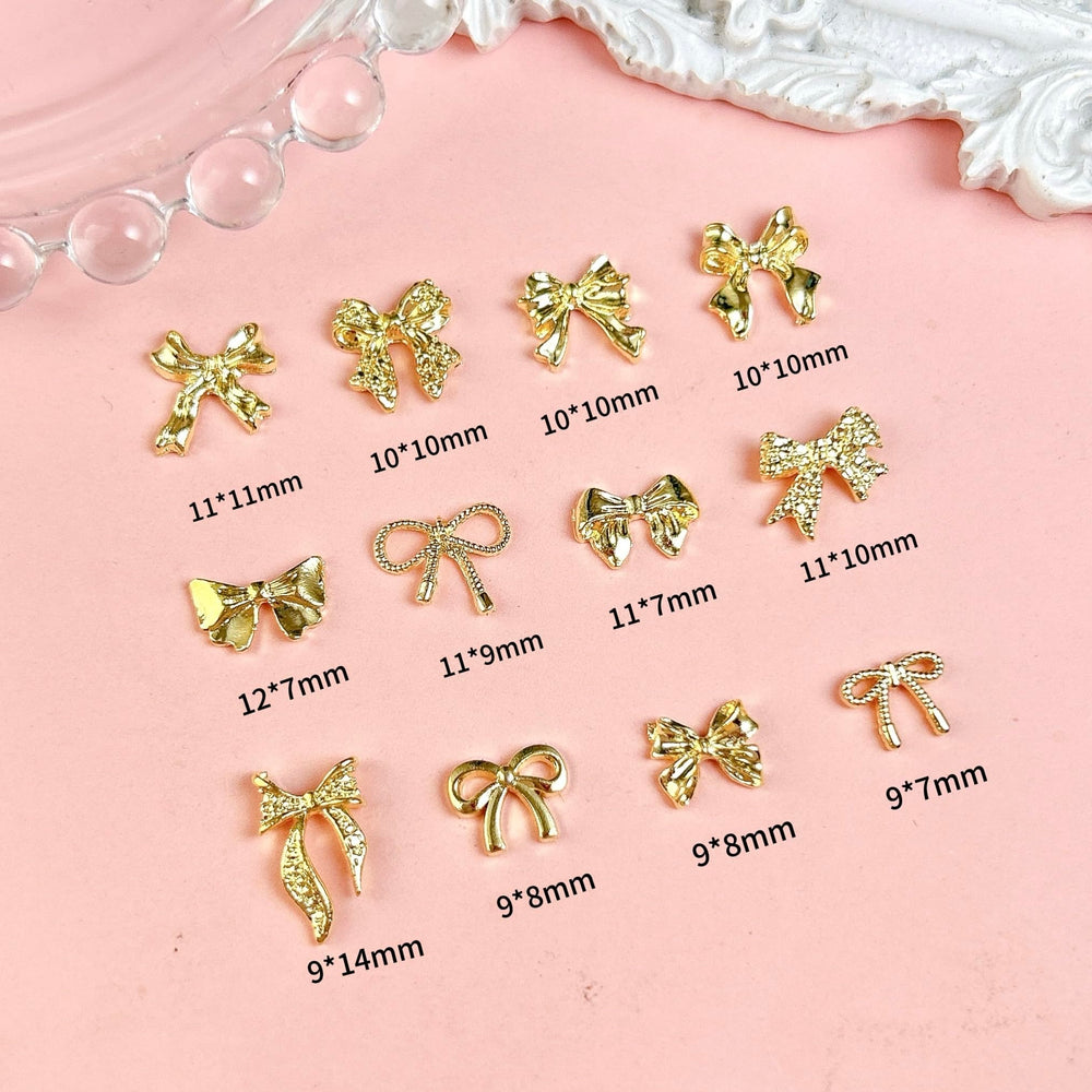 Charme noeud papillon doré BANA ART pour ongles, idéal pour décoration ongulaire.