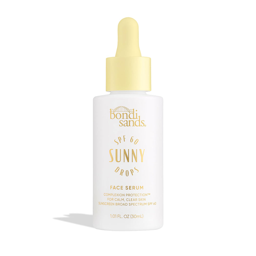 Bondi Sands Sunny Drops SPF 60 serum bottle close-up showing sheer protection on skin.