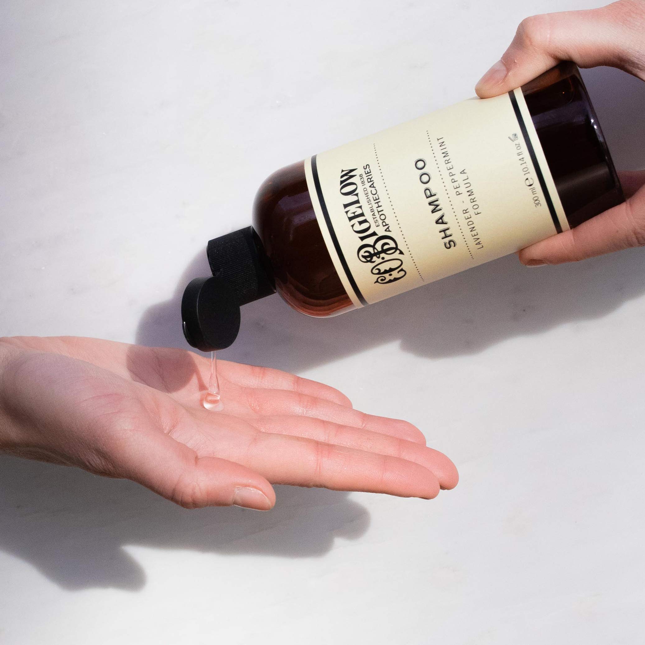 C.O. Bigelow Lavender Peppermint Shampoo pour demonstrates quick rinse with light feel.