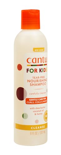 Mains appliquant le shampoing Cantu sur cheveux d’enfant, texture légère et agréable.