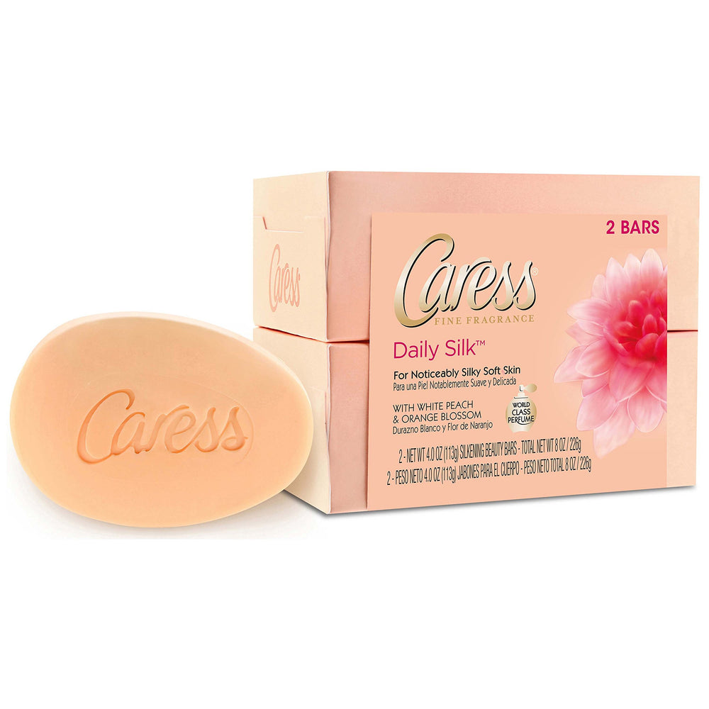 Gros plan sur le parfum et fleurs Caress Soie Quotidienne.