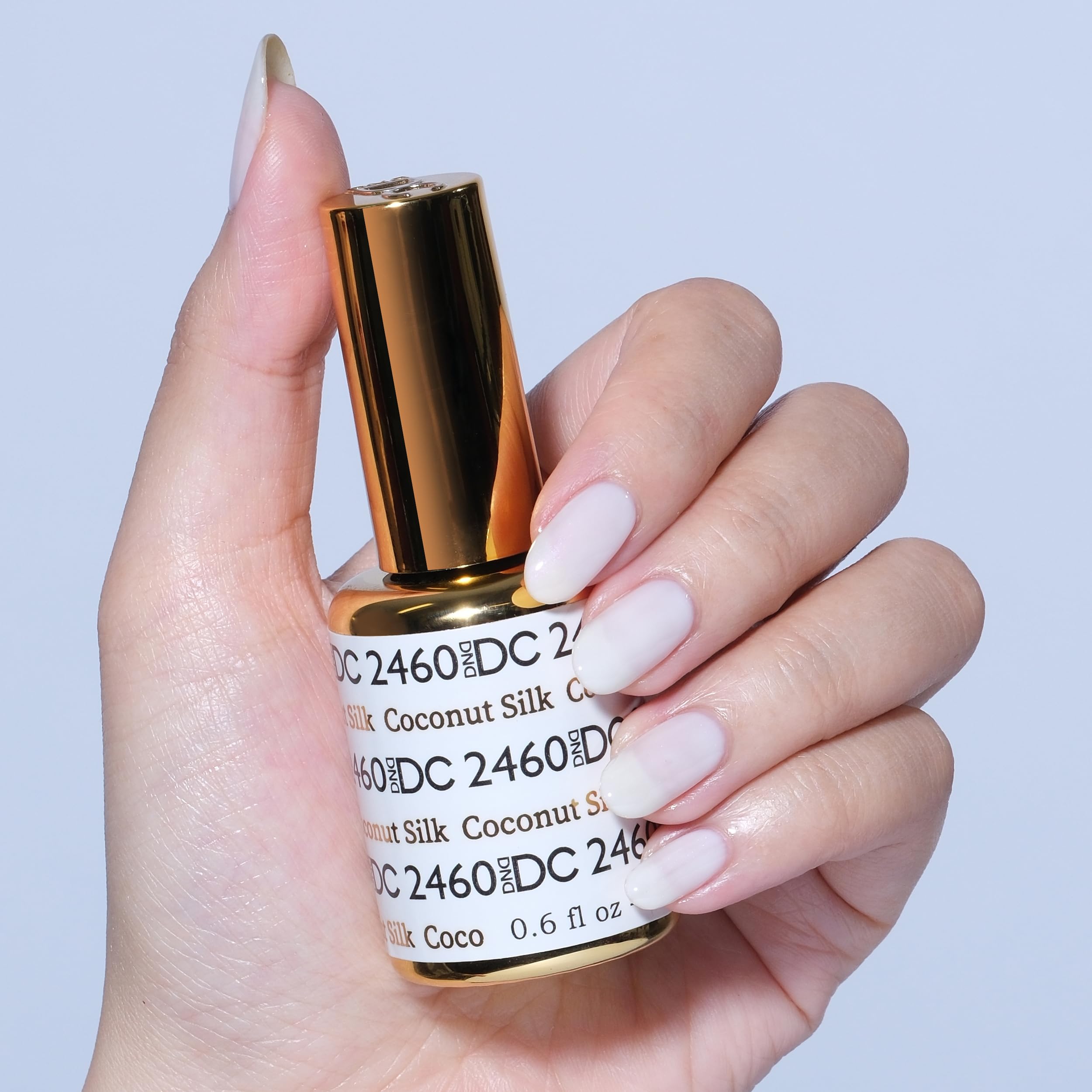DAISY DND Coconut Silk lacquer bottle paired with gel polish for a coordinated mani.