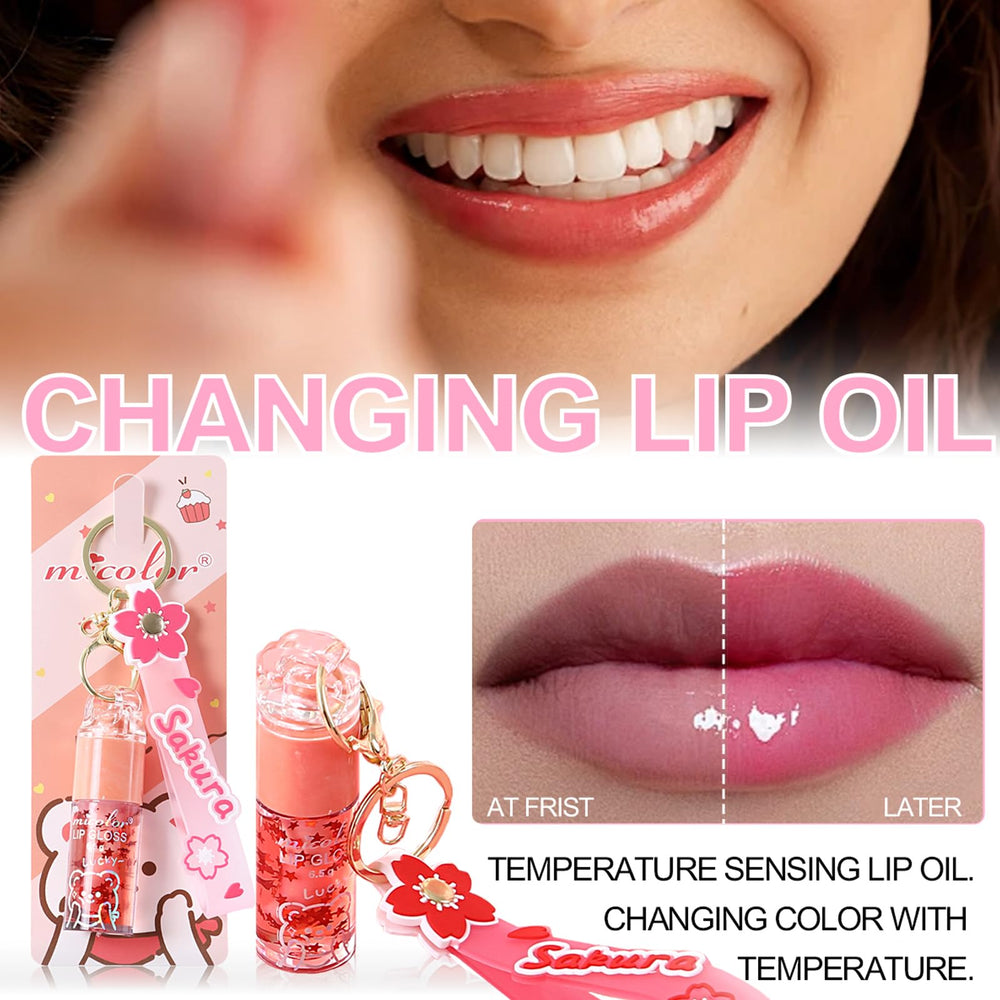 DENESTUP gloss pêche avec pendentif sakura, fini doux et look estival.