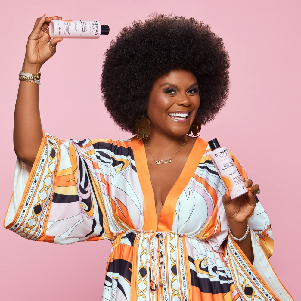Donna's Recipe by Tabitha Brown leave-in bottle being squeezed for radiant shine and soft curls.