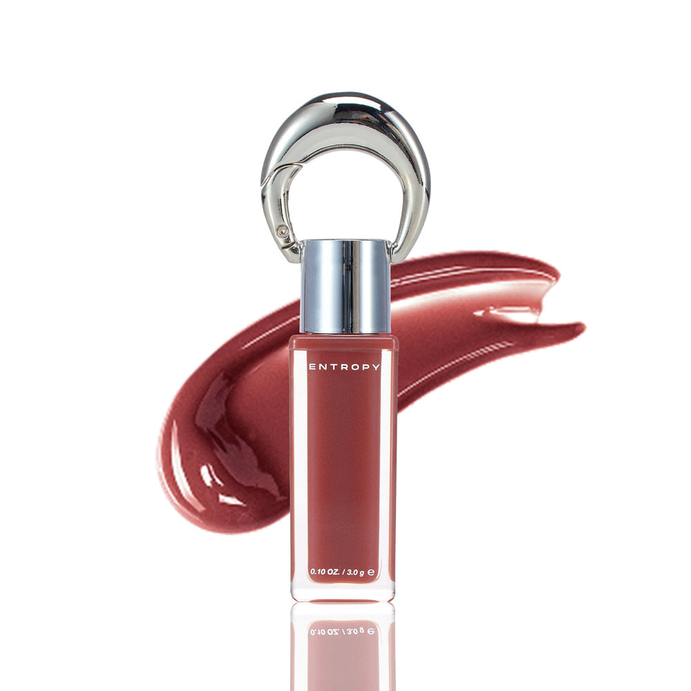 ENTROPY MAKE UP Charme Ambre – bouteille du gloss 2-en-1 prête à briller sur lèvres et joues.