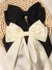 Furling Pompoms noeud satin noir gros, accessoire chic pour coiffures variées