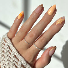 Glamnetic Sunny Shores press-on nails with orange shade and 3D starfish for beach-inspired look.