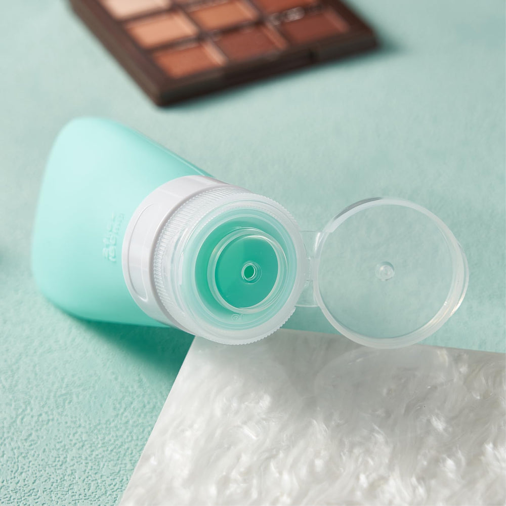 INSFIT bouteilles voyage silicone rose 2 oz, parfaites pour gel douche et après-shampoing.