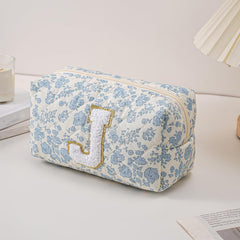 JOVAKIT sac maquillage bleu fleuri ouvert, grand compartiment pour pinceaux et rouges a levres.