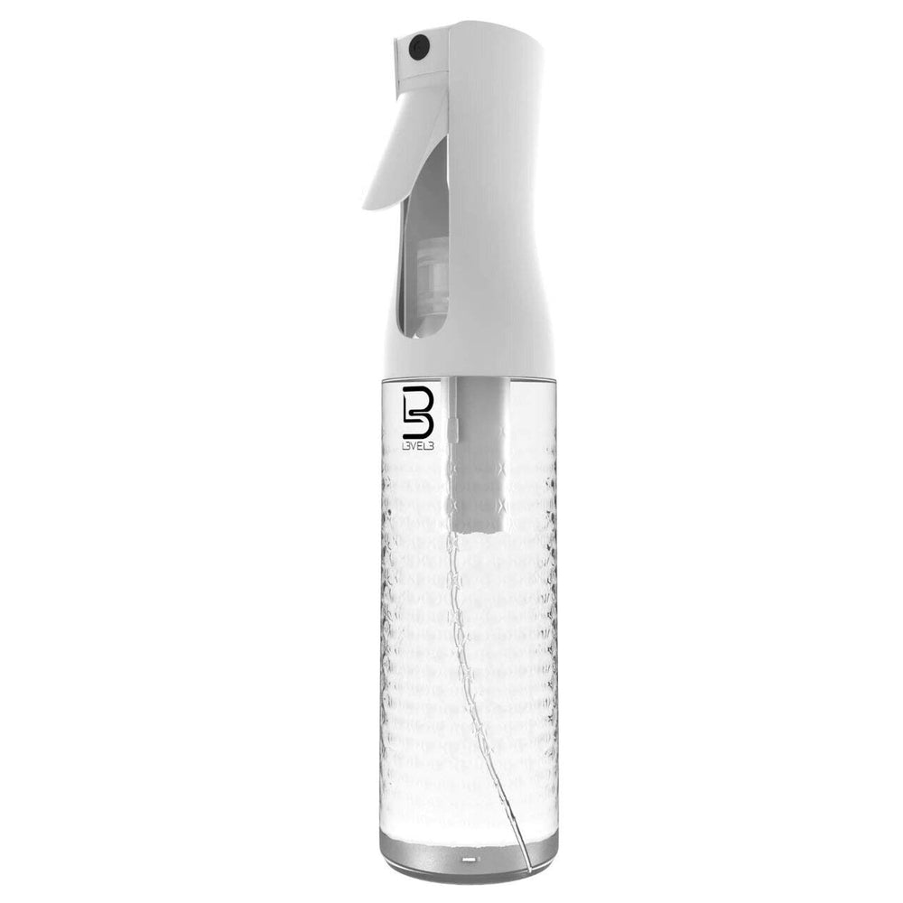 Bouteille spray L3 démontrant une diffusion continue avec brume fine pour coiffure précise.