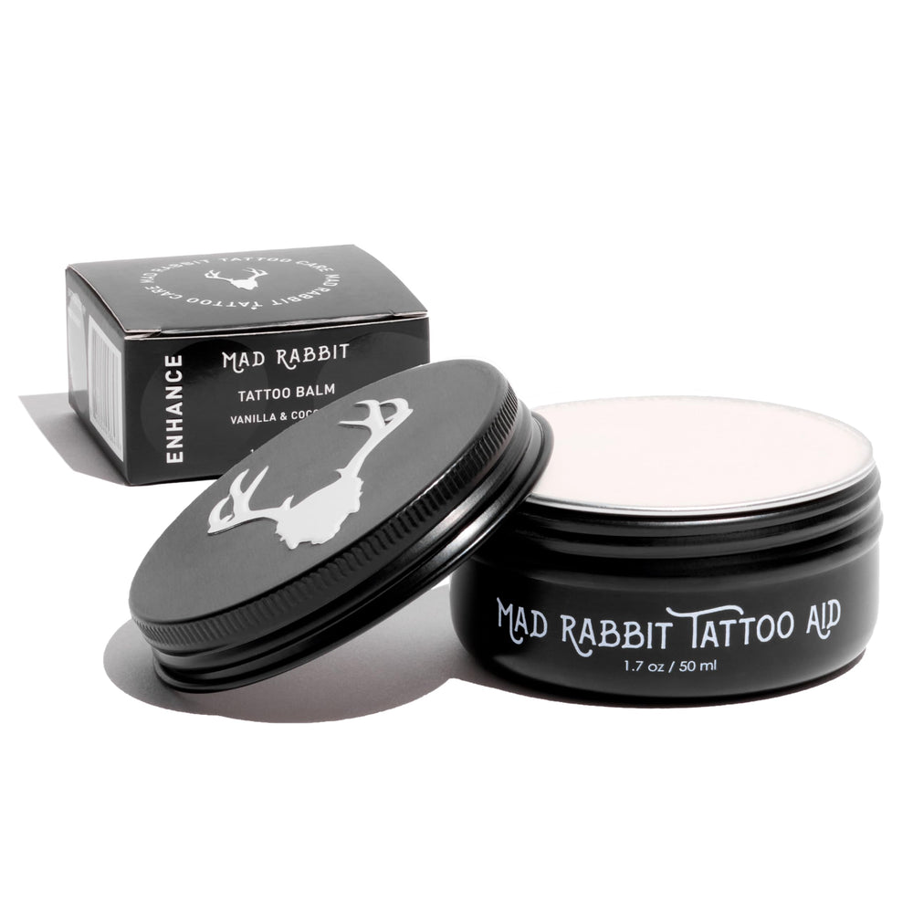 Mad Rabbit Tattoo Balm bottle close-up showing hydration for vibrant ink.