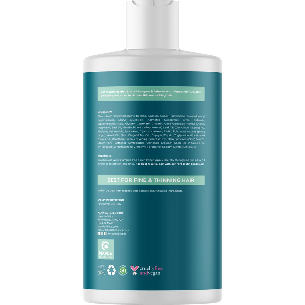 Feuilles de menthe fraîches avec le flacon Maple Holistics en arrière-plan.