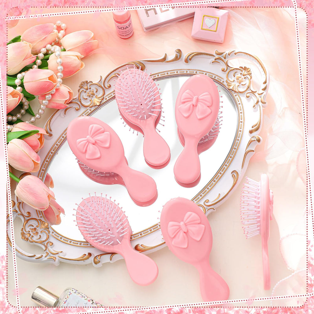 Meanplan brosse mini-coquette rose format voyage facilement glissée dans un sac.