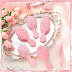 Meanplan brosse mini-coquette rose format voyage facilement glissée dans un sac.