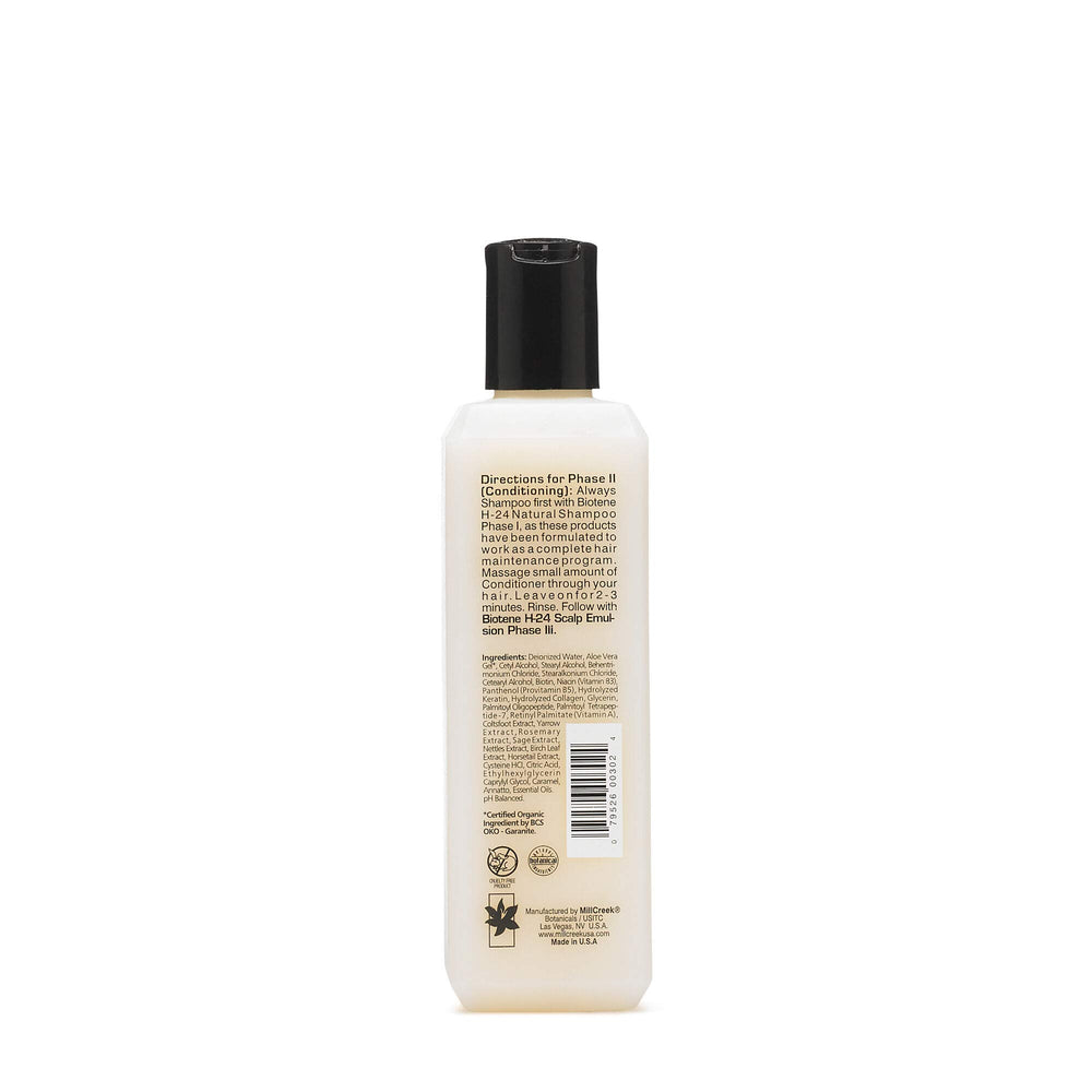 Mill Creek Biotin H24 conditioner tube close-up highlighting rich texture.