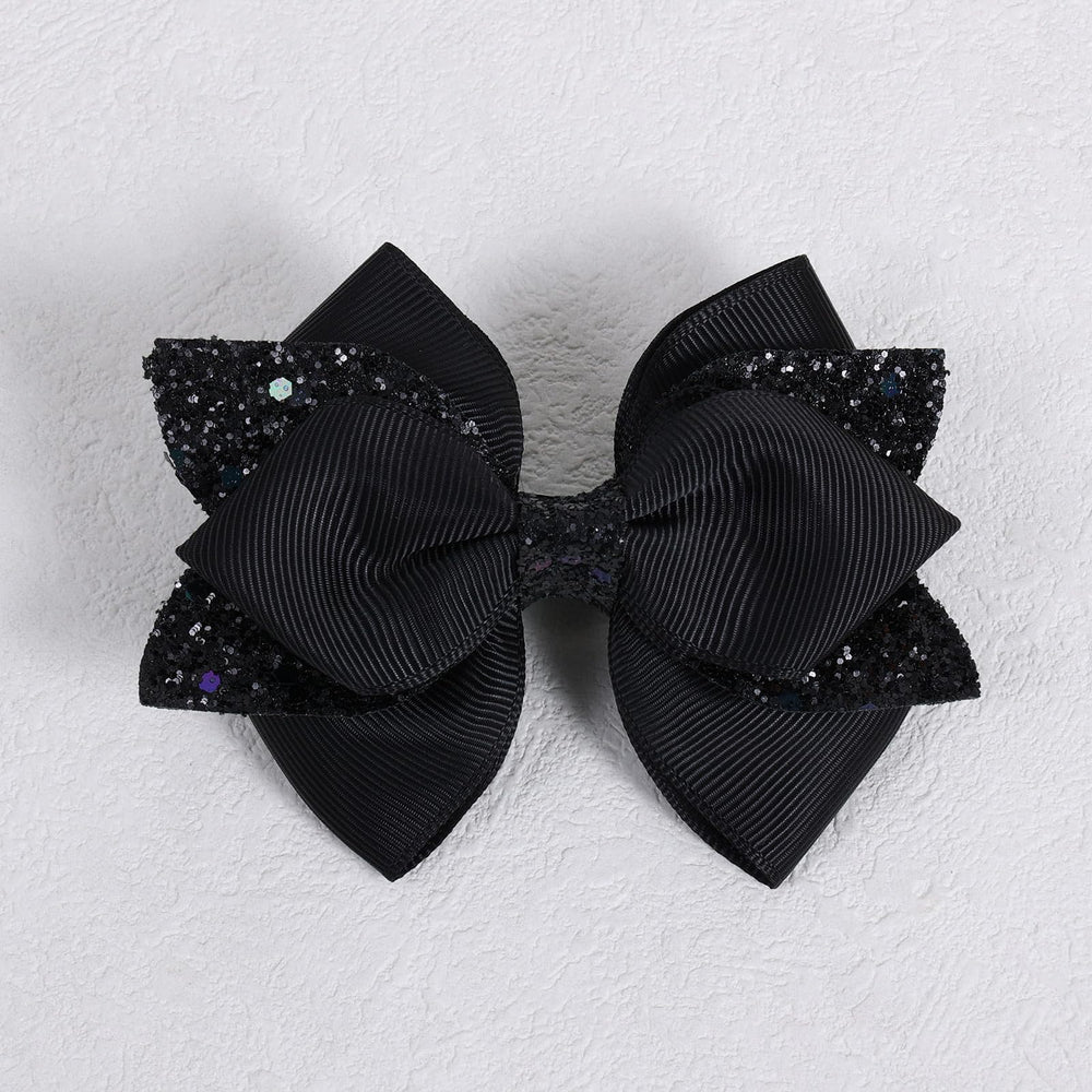 Barrette Miroksh ruban noir brillant, adaptée à tous types de cheveux.