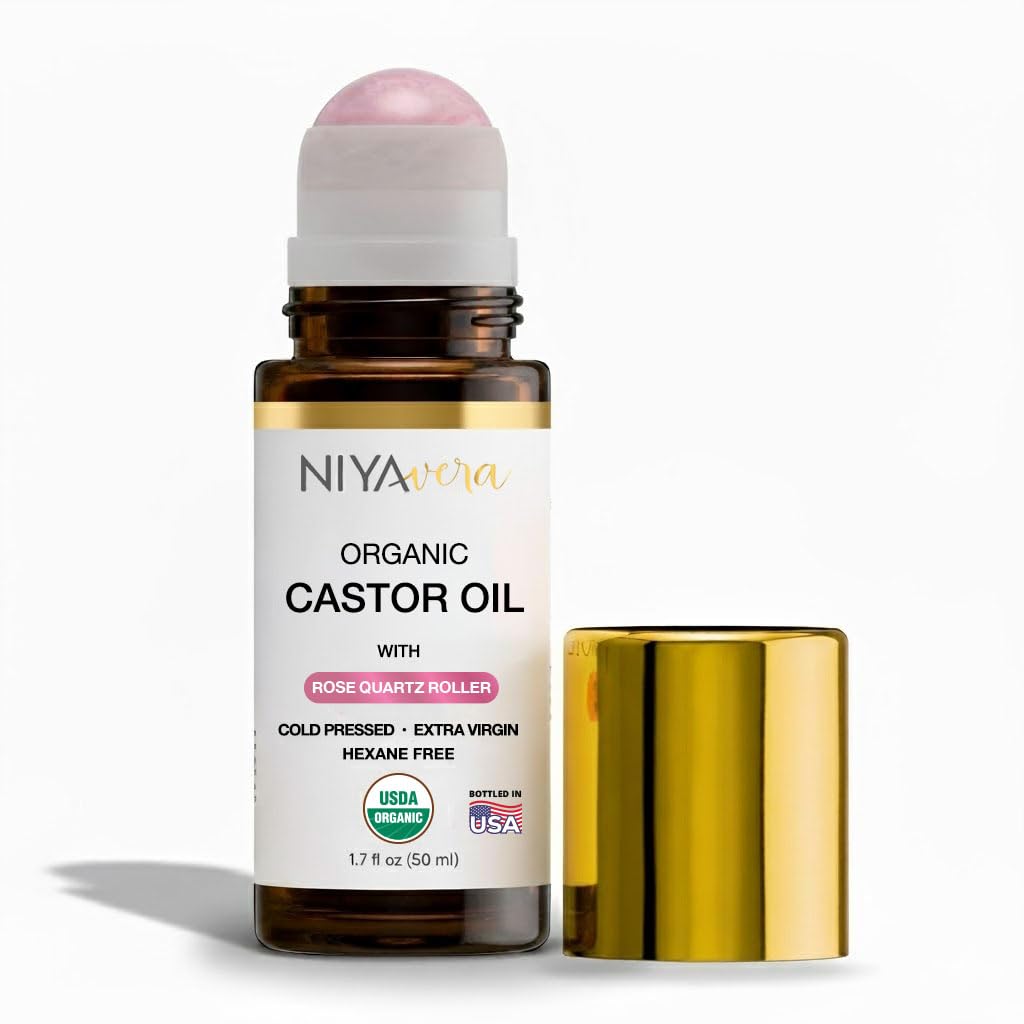 NIYAVERA organic castor oil with rose quartz roller for facial nourishment.