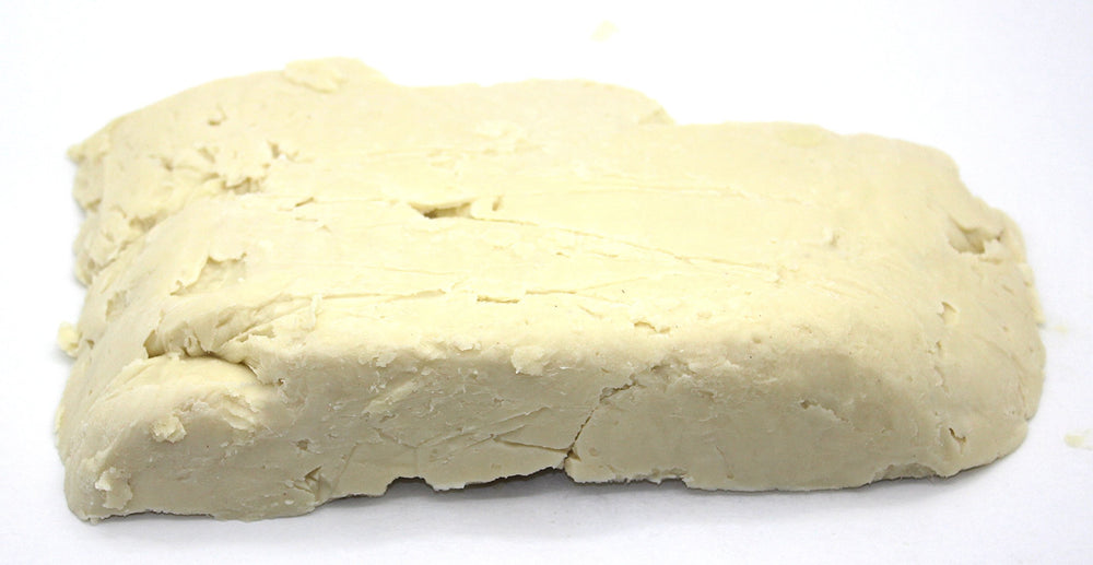 Our Earth's Secrets Ivory Shea butter close-up showing creamy texture for nourishing skin.