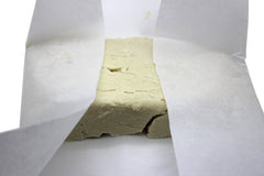Our Earth's Secrets Ivory Shea butter applied to skin for smoothing and hydration.