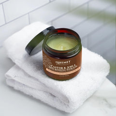 Qhemet Biologics Castor and Amla pomade texture being smoothed into hair for pliability.